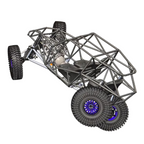 Computer monitor displaying a 3D model of a vehicle on a desk with a keyboard and speakers.